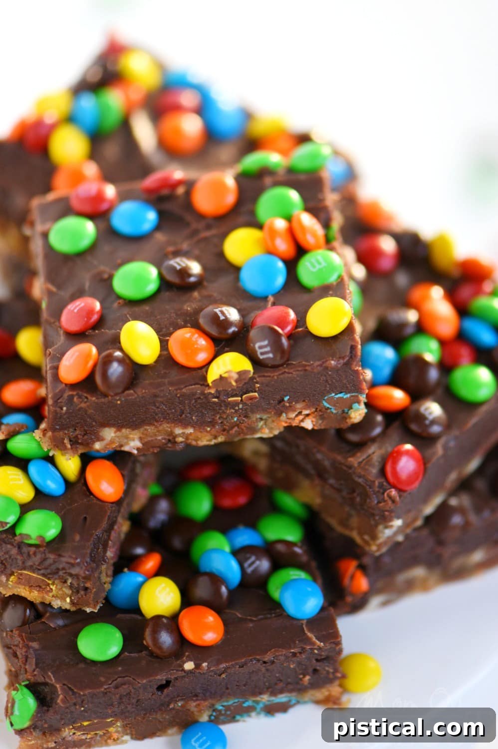 Perfectly cut squares of Monster Fudge Bars, showing the distinct cookie and fudge layers.