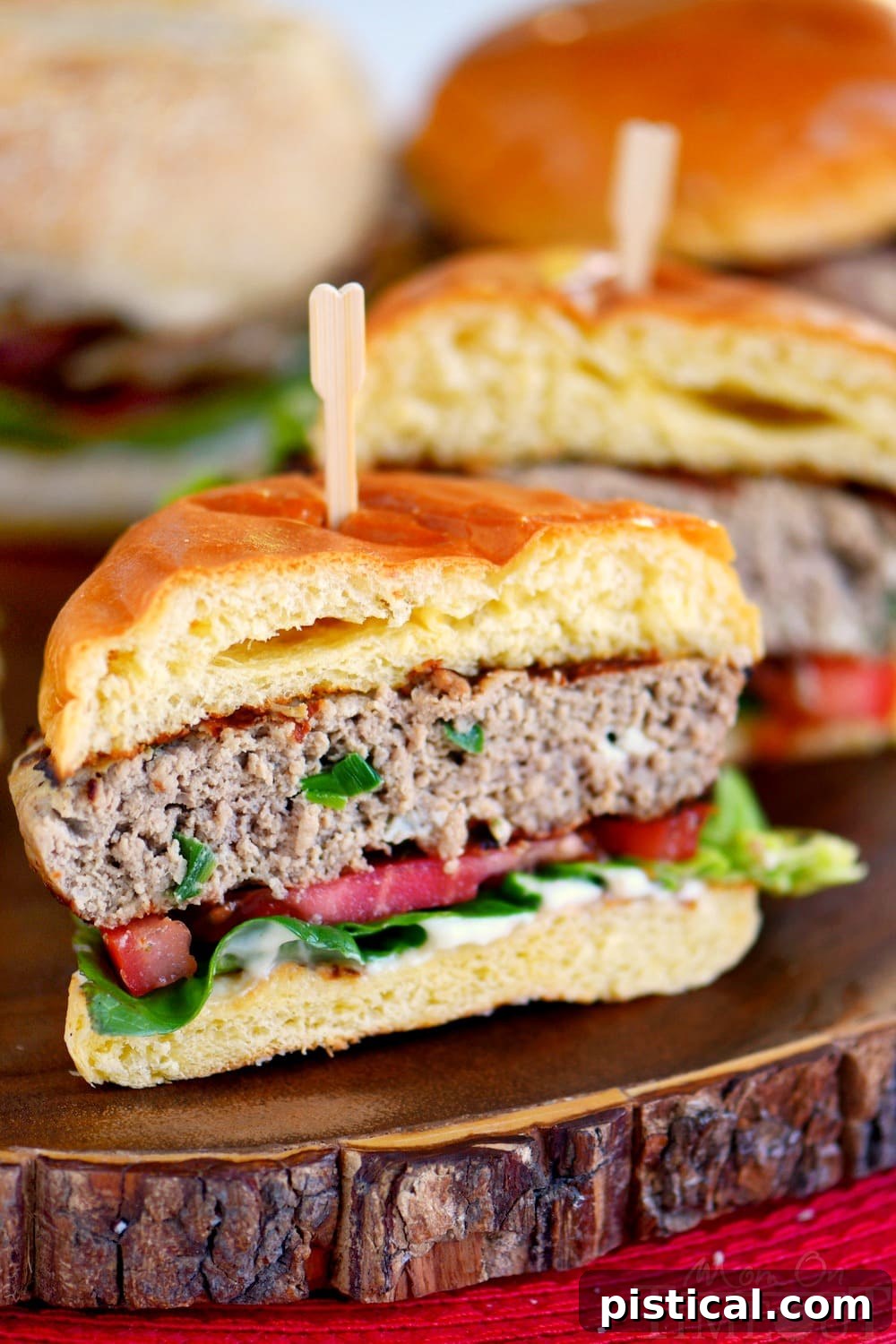 Inside out turkey burger cut in half, showcasing the melted mozzarella and green onion within the patty.