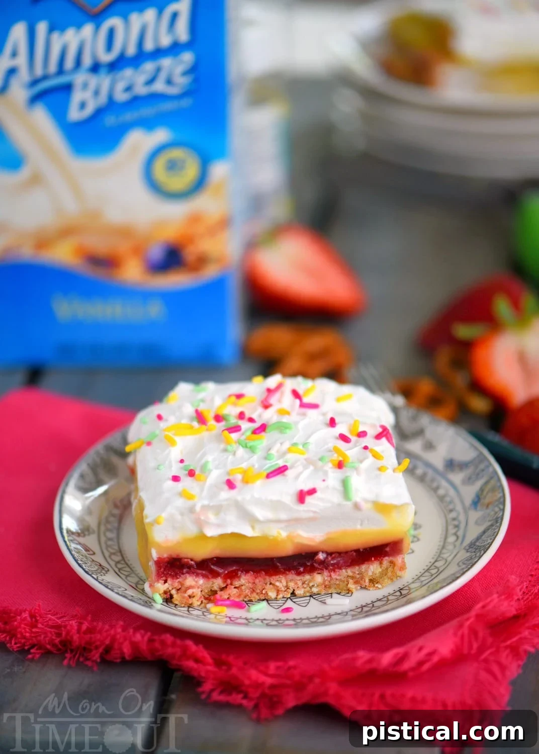 This easy No Bake Strawberry Pretzel Layered Dessert is sure to become a new family favorite! A graham cracker-pretzel crust is topped with a sweet strawberry jell-o layer, rich vanilla pudding and creamy whipped topping! Don't forget the sprinkles!