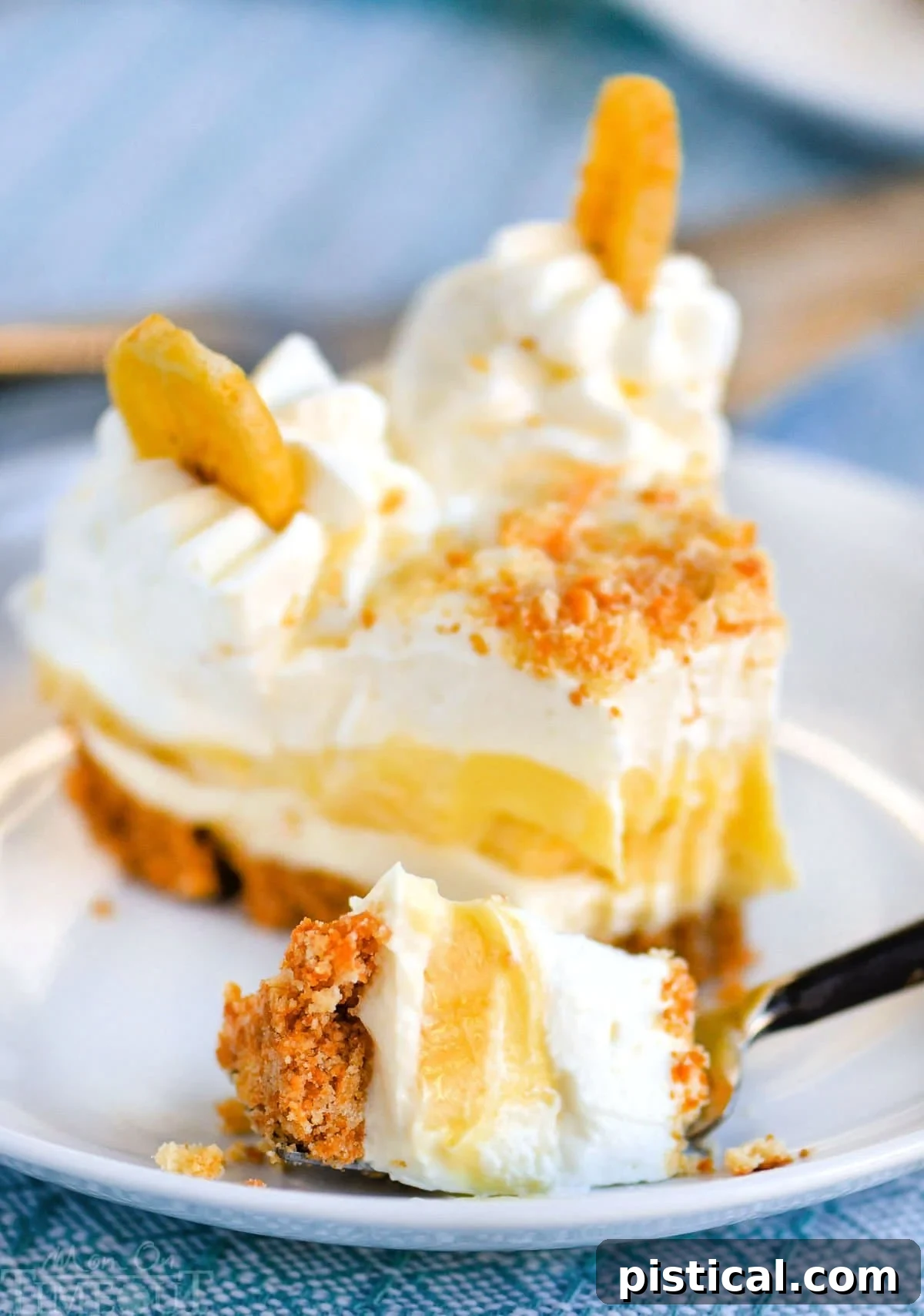 Velvet Banana Pudding Cheesecake 6 Slice of no bake banana pudding cheesecake recipe on plate with a bite removed with a fork.