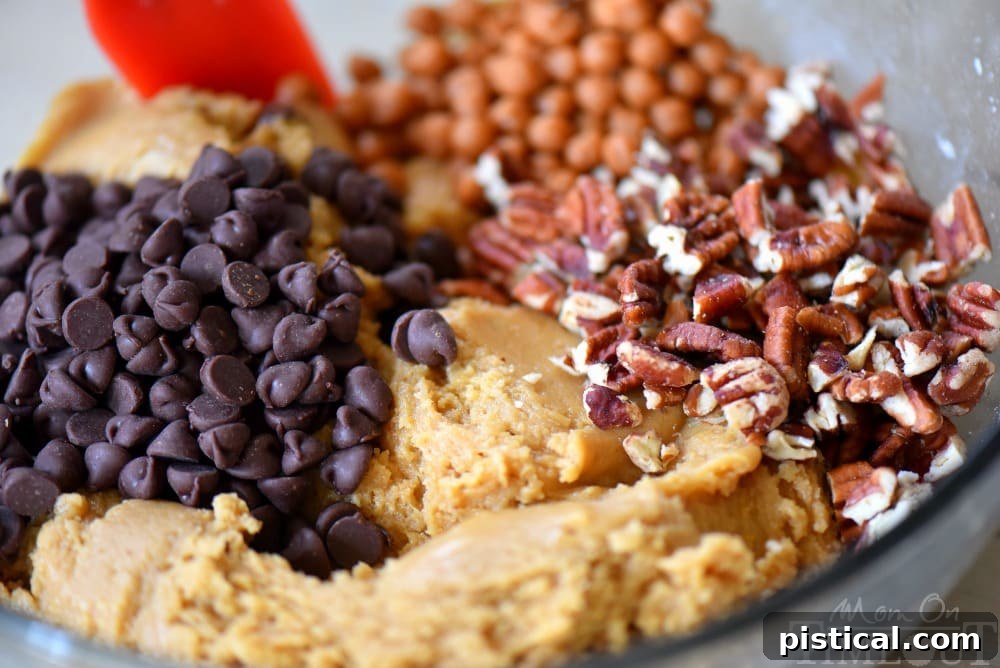 Close-up of Chocolate Chip Turtle Pudding Cookies with visible chocolate chips, pecans, and caramel.