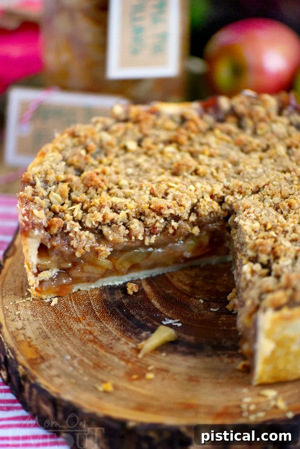 A delicious Deep Dish Dutch Apple Pie, featuring a robust spiced apple filling and a delightful pecan streusel. Ideal for festive fall gatherings, especially with a side of vanilla ice cream and caramel.