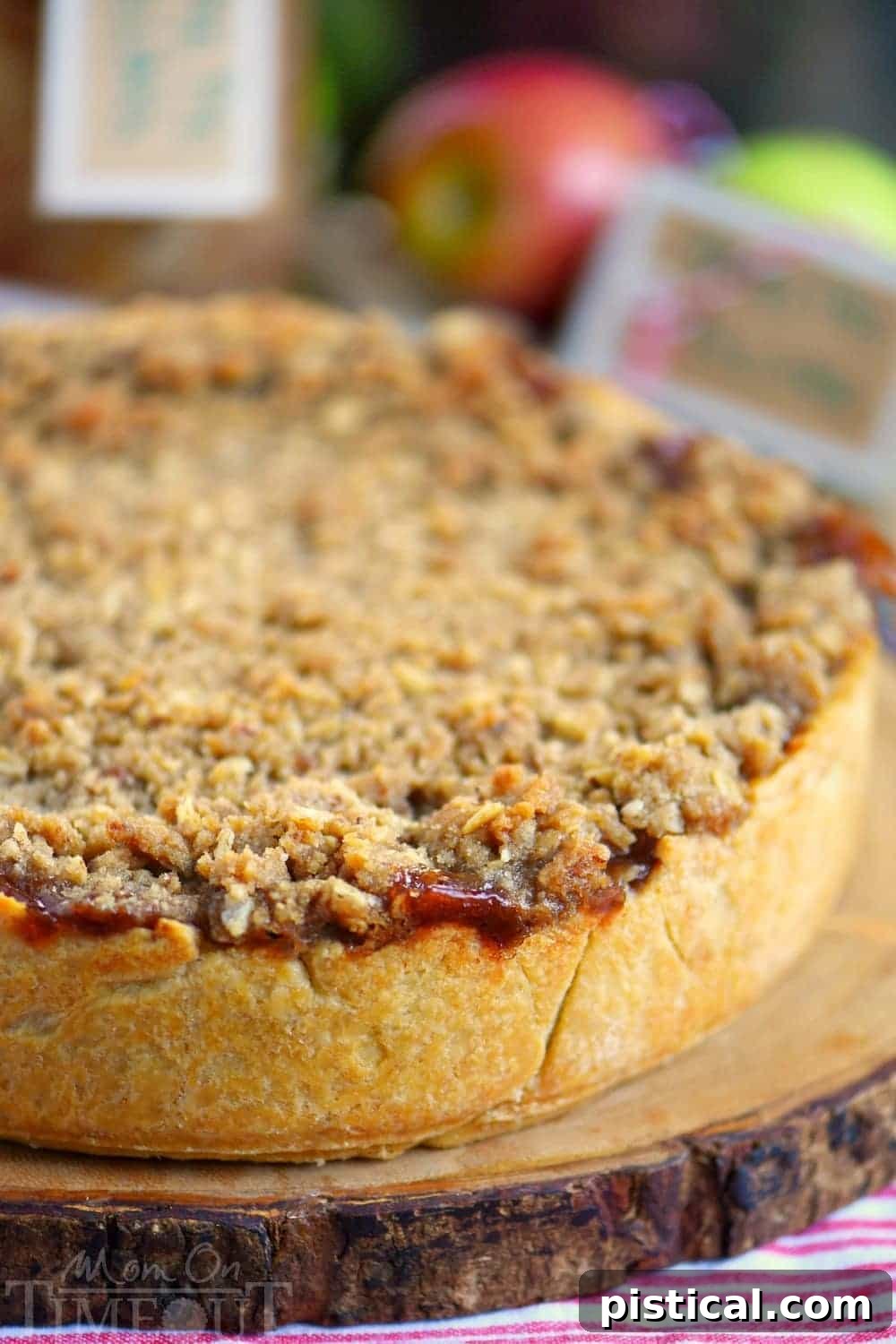 Deep Dish Dutch Apple Pie ready for the oven, filled with spiced apples and topped with pecan streusel, promising a perfect fall dessert.