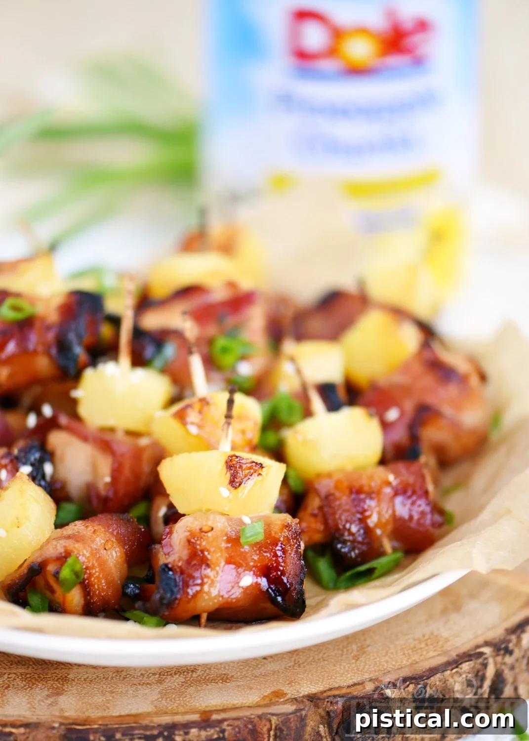 Bacon-Wrapped Teriyaki Chicken Poppers 4 Platter of freshly baked Bacon Wrapped Chicken Teriyaki Bites garnished with chopped green onions.