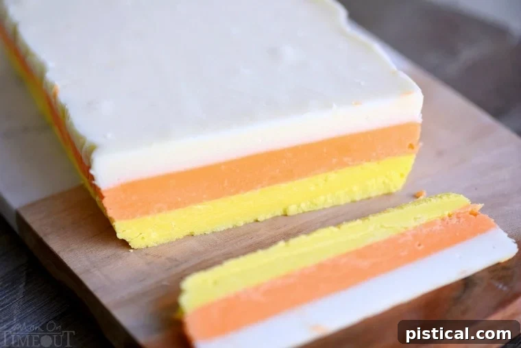 Two-toned candy corn fudge layers in a loaf pan before the final white layer is added.