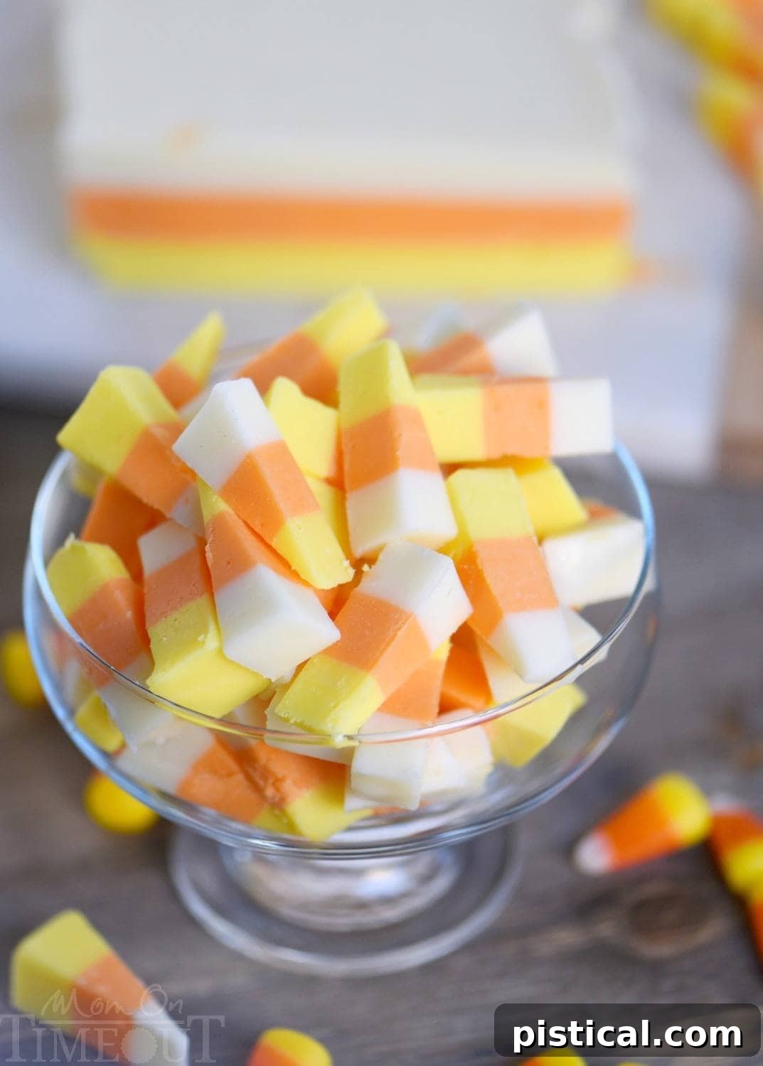 Close-up of freshly cut Candy Corn Fudge triangles, showing perfect layers and a creamy texture.