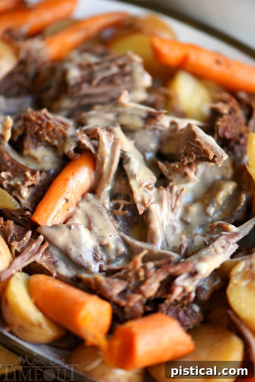 Perfect Pot Roast and Gravy pot roast plated with gravy and vegetables