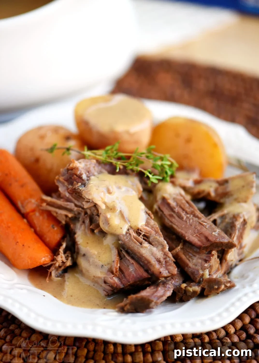 Homemade Pot Roast Dinner pot roast recipe with gravy on plate with potatoes and carrots