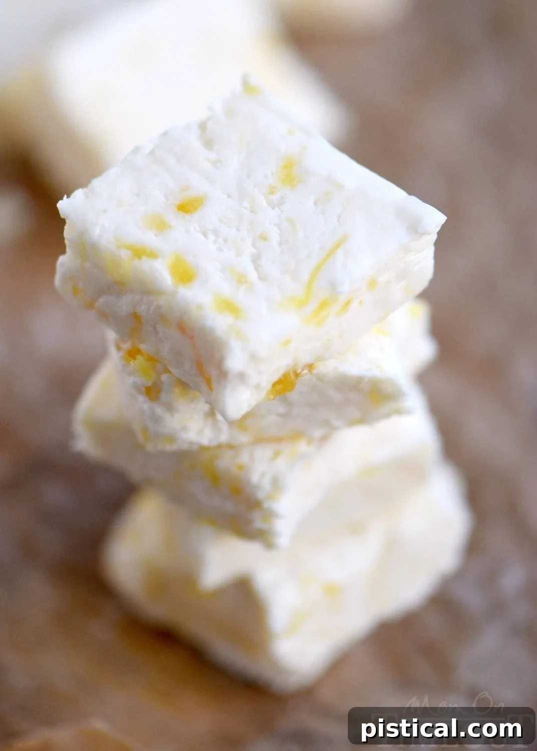 Delicious squares of pineapple fudge, showcasing its creamy texture and pineapple chunks, ready to be enjoyed.