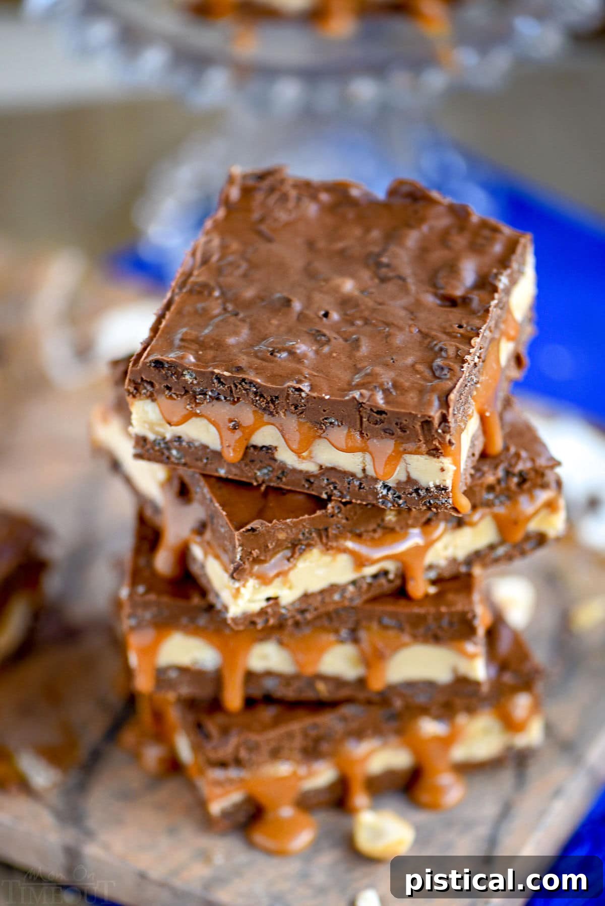 A top-down view of a stack of crispy Snickers bars, with tempting caramel dripping enticingly from the sides.