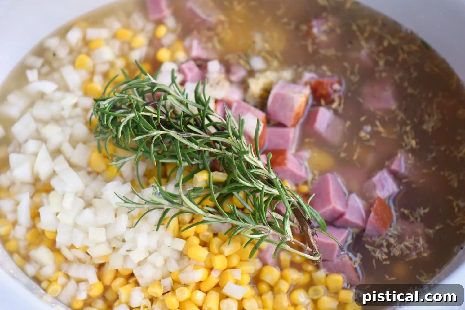 Love slow cooker recipes? This one is for you! This Slow Cooker Rosemary Potato Soup with Ham and Corn is all about filling your belly with goodness and warmth! Weeknight dinners have never tasted this good! // Mom On Timeout