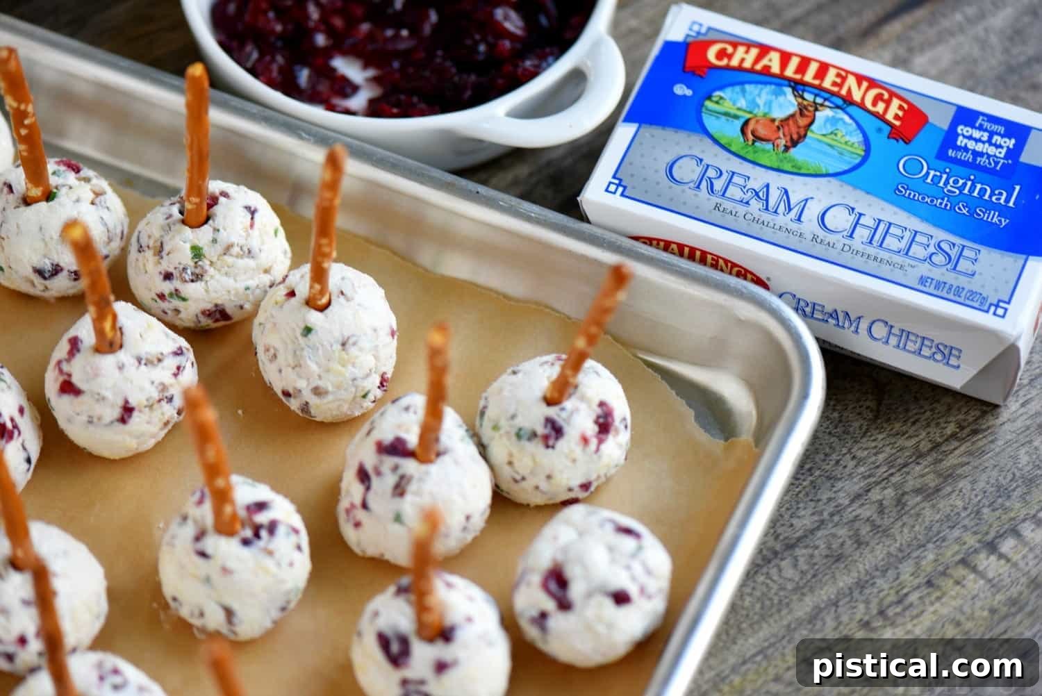 Sweet and Tangy Cranberry Pecan Goat Cheese Truffles 5 An array of Cranberry Pecan Mini Goat Cheese Balls, ready to serve with crackers and pretzels, highlighting their perfect size for individual portions during holiday parties.