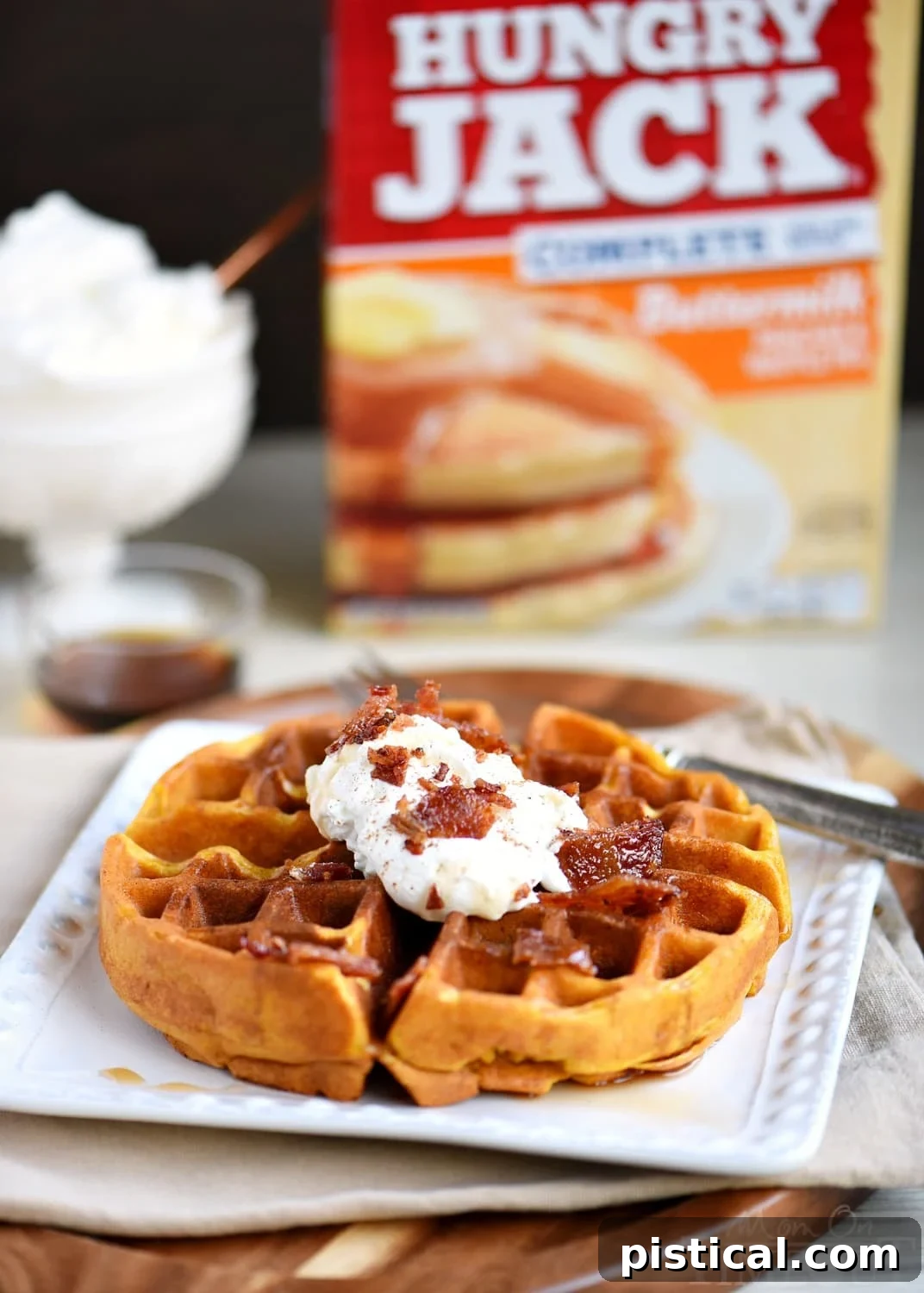 Close-up of golden Pumpkin Spice Maple Bacon Waffles, showing their soft texture and hints of bacon inside, prepared for serving.