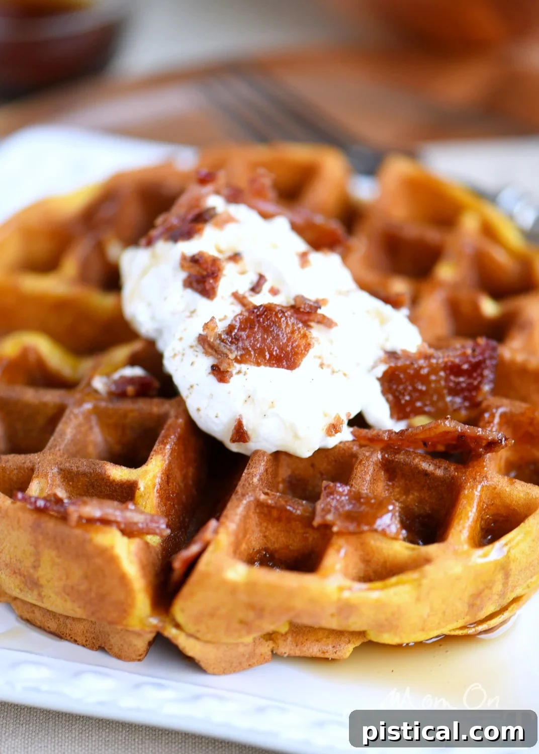 Pumpkin Spice Maple Bacon Waffle batter being mixed in a bowl, showing its creamy texture and rich color.