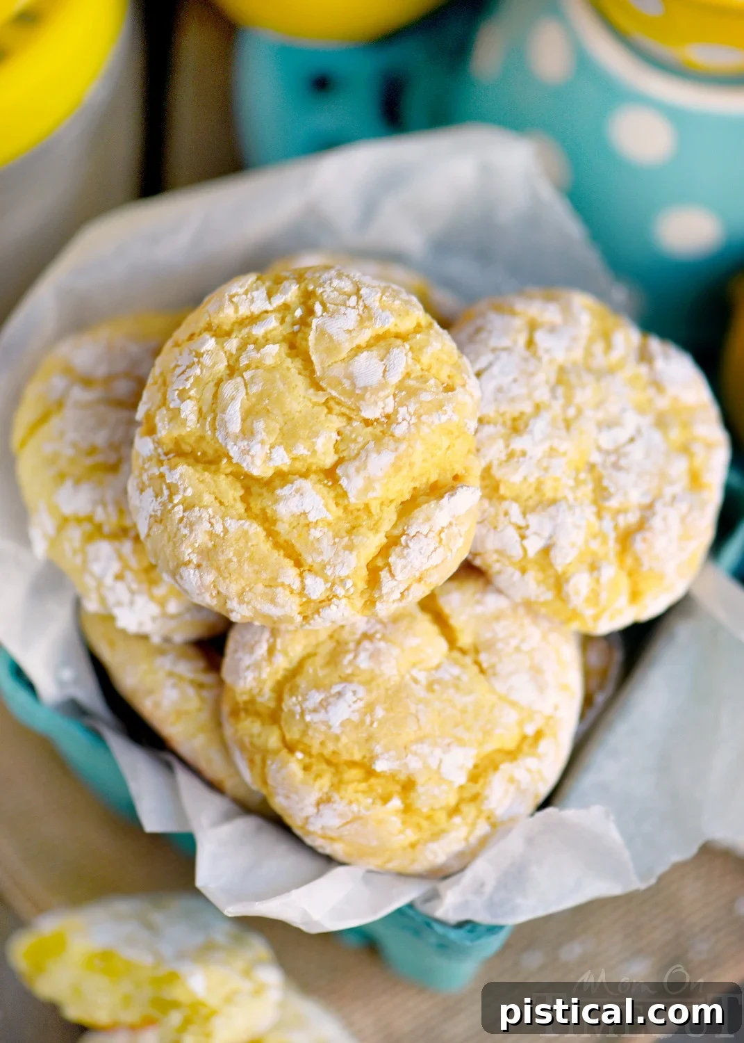 Close-up of freshly baked Lemon Cookies, showcasing their beautiful cracked powdered sugar tops and soft texture.