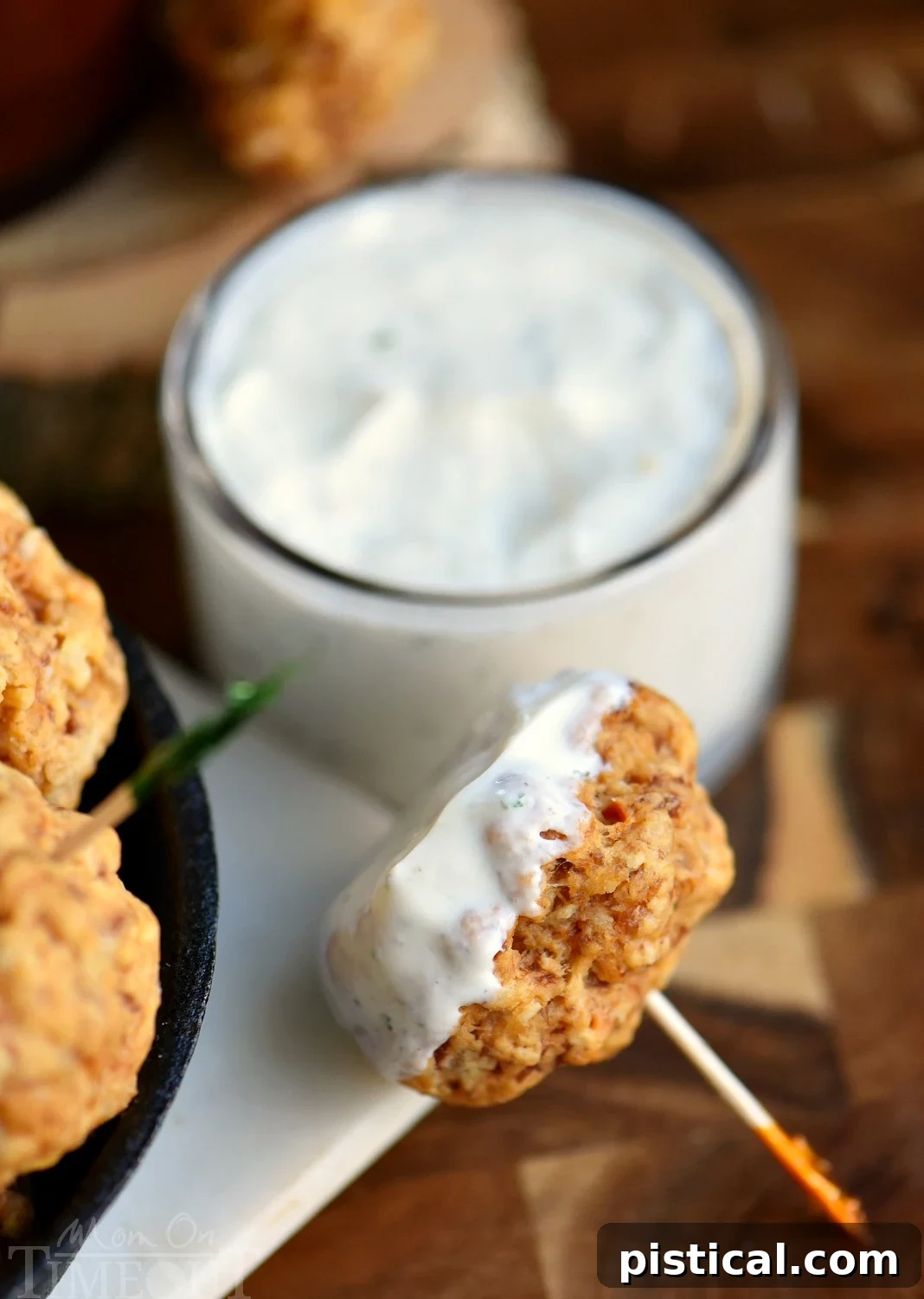 The BEST Sausage Balls are guaranteed to be a hit at your next party! So delicious, incredibly easy and perfect for game day! We like to dip them in ranch, bbq sauce, or marinara - so good! Close-up of golden brown sausage balls on a baking sheet, fresh from the oven.