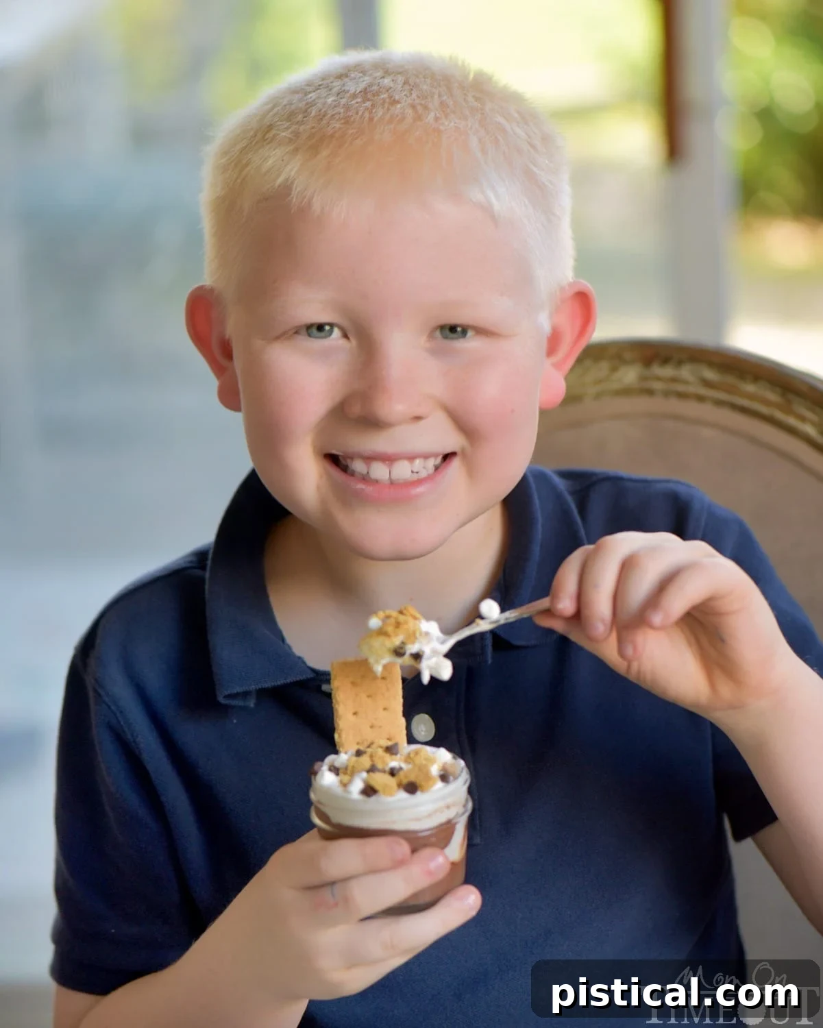A child's hands preparing S'mores Pudding Parfaits, showing the fun and ease of making this dessert with kids.