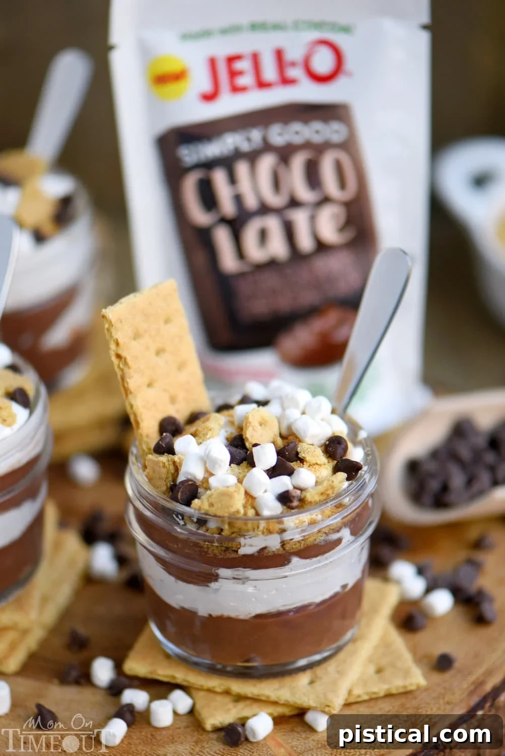 Another image of S'mores Pudding Parfaits being assembled, highlighting the layers and the hands-on fun.
