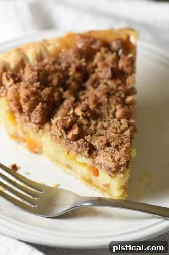 A rustic Sour Cream Peach Pie, with a juicy peach filling, a hint of sour cream for tang, and a golden lattice top crust.