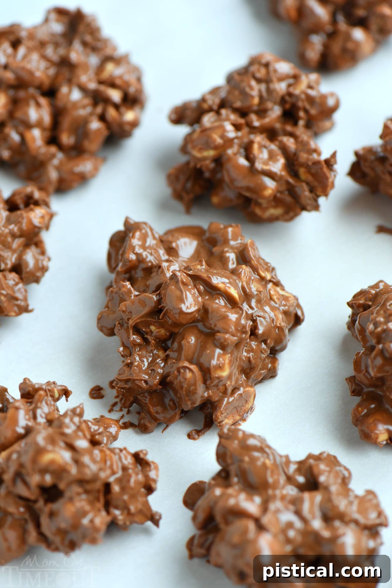 Golden Toffee Peanut Delights 3 Several large Toffee Peanut Clusters artfully arranged on parchment paper, showcasing the generous amount of peanuts and toffee bits in each cluster. An ideal homemade gift.