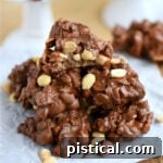 Peanut clusters made with toffee, piled high on a crumpled piece of parchment, showcasing their inviting texture.