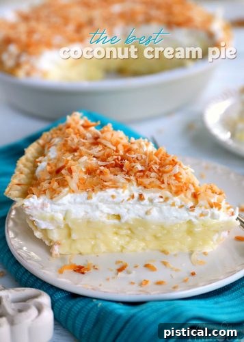A slice of the best coconut cream pie with a flaky crust, rich coconut custard, and fluffy whipped cream topping, garnished with toasted coconut.