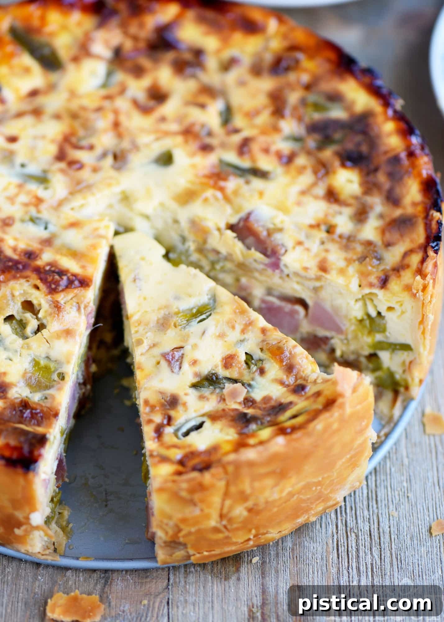 Sumptuous Deep Dish Ham and Asparagus Quiche 3 Close-up of the golden-brown crust and fluffy interior of the Deep Dish Ham and Asparagus Quiche.