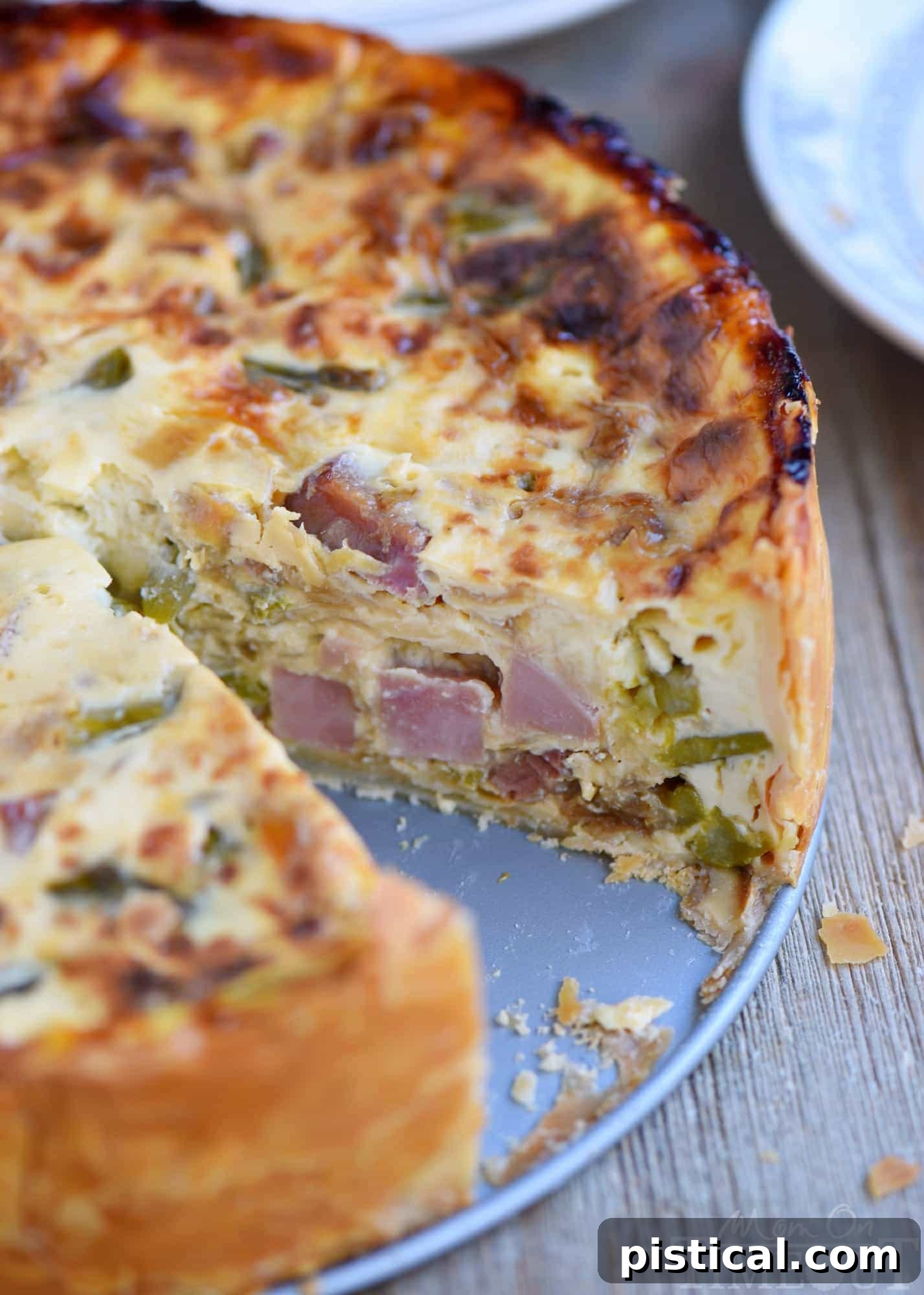 Sumptuous Deep Dish Ham and Asparagus Quiche 4 A whole Deep Dish Ham and Asparagus Quiche cooling on a wire rack, showcasing its impressive height.