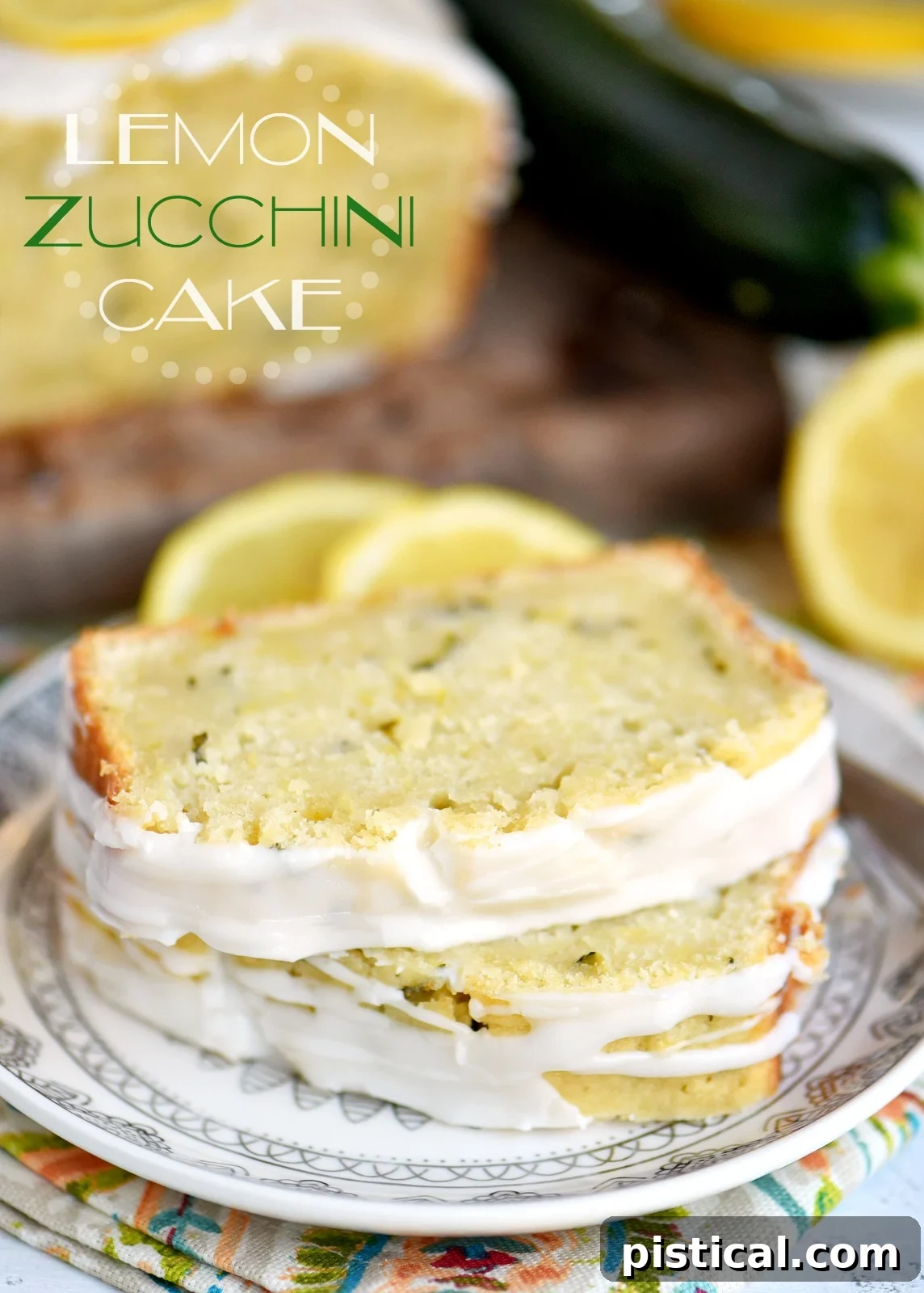 A slice of moist Lemon Zucchini Cake with a sweet lemon glaze, presented on a white plate next to a fresh lemon.