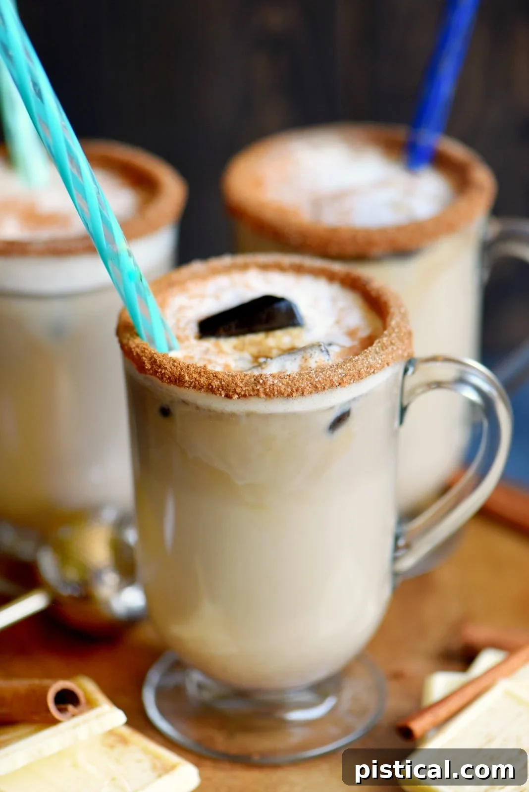 Frosted White Chocolate Snickerdoodle Latte 3 Two mugs showcasing the versatility of the White Chocolate Snickerdoodle Latte: one hot, garnished with whipped cream and cinnamon, and the other a refreshing iced version. This image emphasizes that the homemade latte can be enjoyed year-round, catering to different preferences and climates.