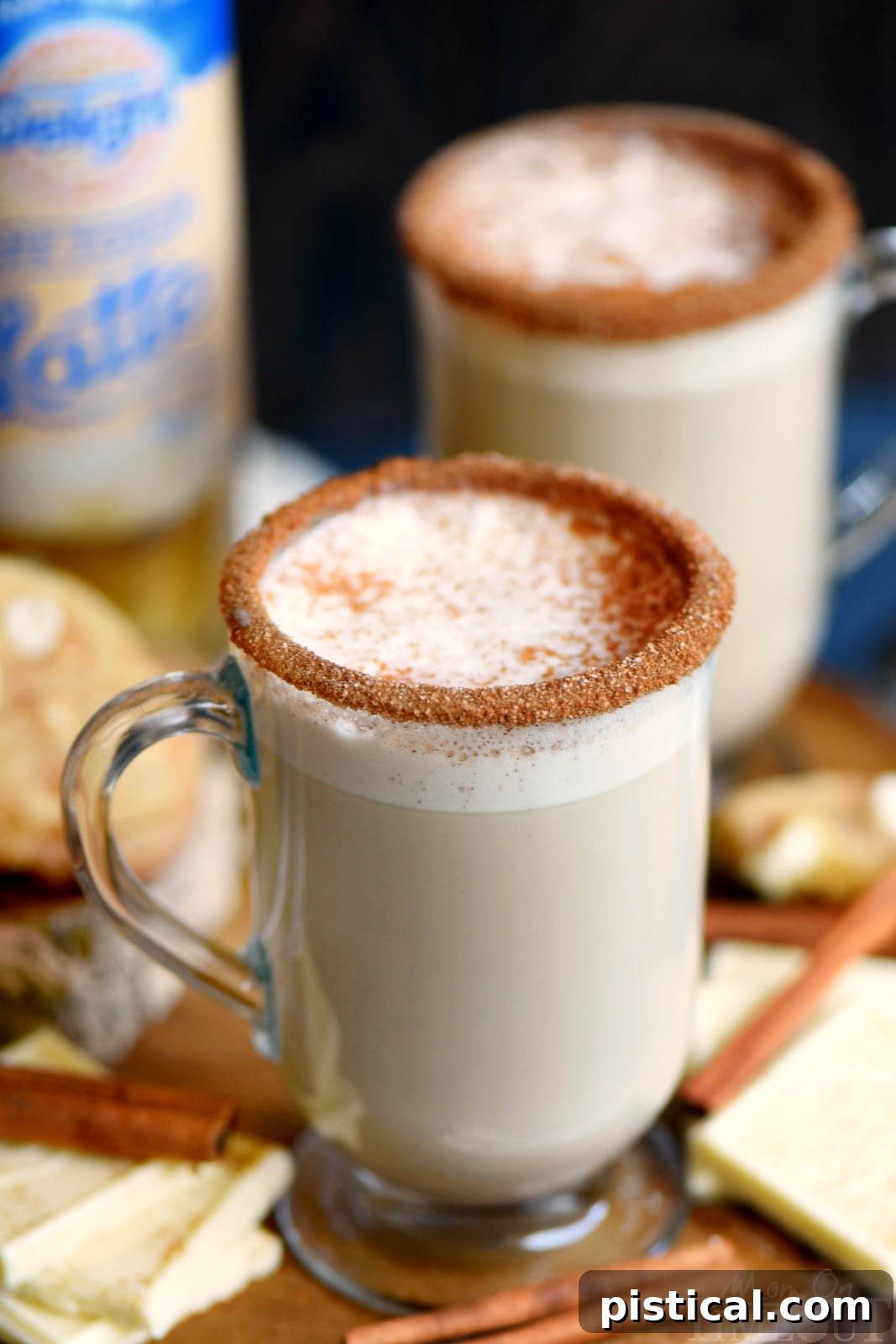 Frosted White Chocolate Snickerdoodle Latte 5 A close-up of a White Chocolate Snickerdoodle Latte, beautifully presented in a glass, highlighting its creamy texture and the delicate sprinkle of cinnamon on top. This inviting shot emphasizes the exquisite flavor blend of white chocolate, vanilla, and cinnamon, creating a truly gourmet experience at home.