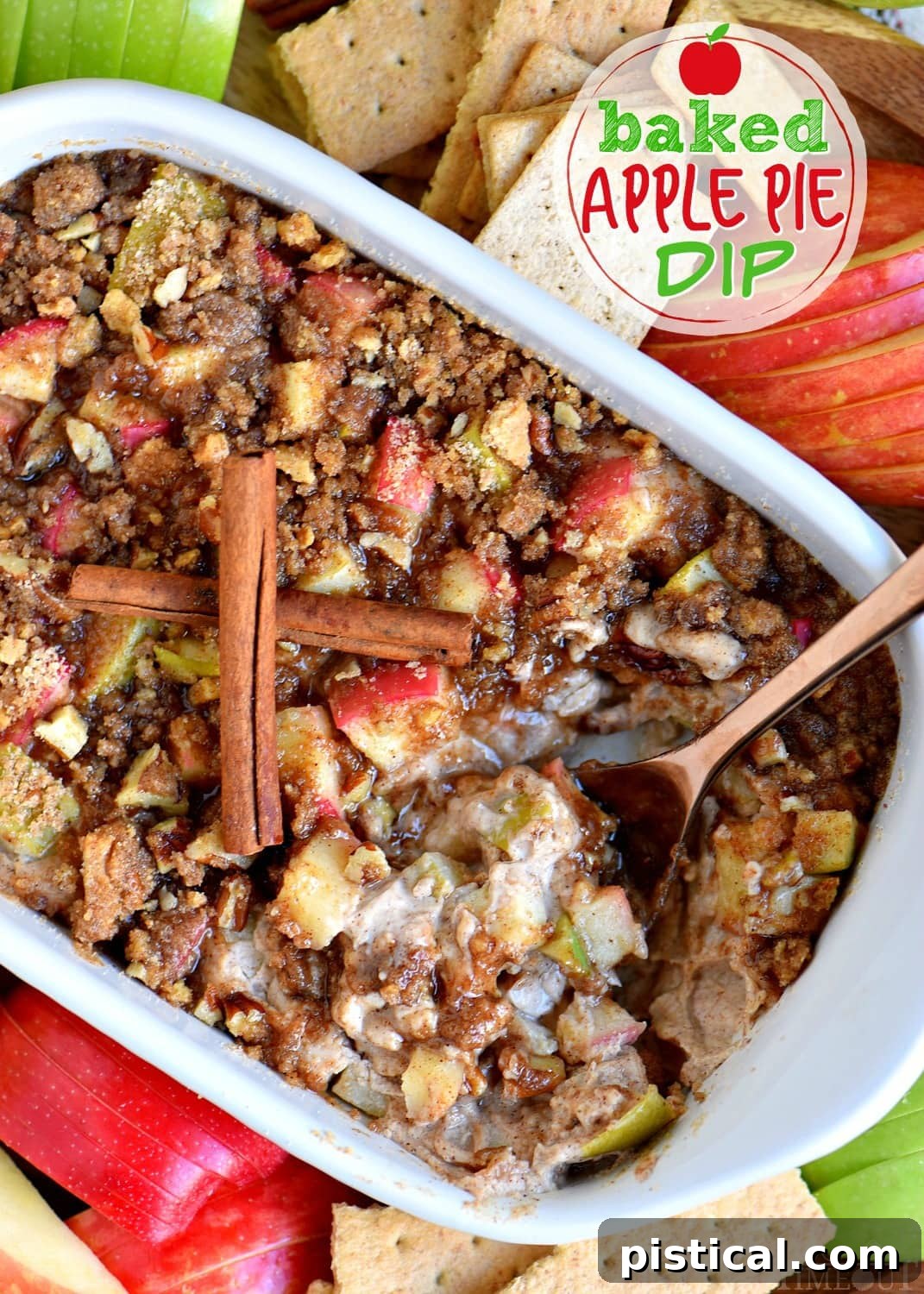 Baked Apple Pie Dip with pecan streusel topping, garnished with a sprinkle of cinnamon, ready for serving with dippers.