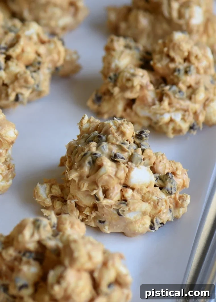 No Bake Avalanche Popcorn Treats are a must-make for the holiday season! Peanut butter, popcorn, marshmallows and chocolate chips combine for an easy, no bake treat that everyone will love! // Mom On Timeout cookie sheet