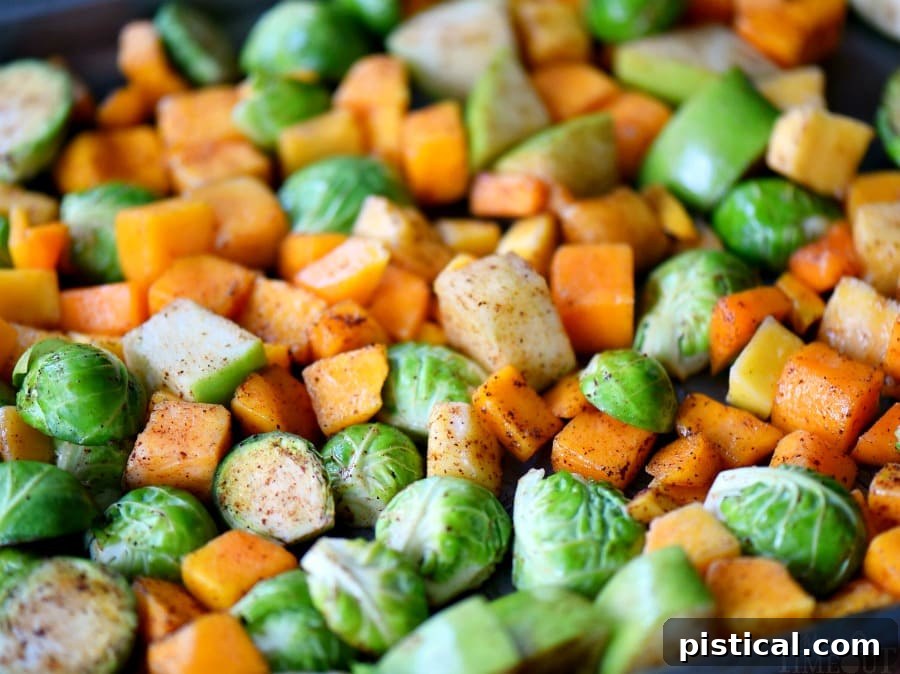 Perfectly spiced roasted Brussels sprouts with squash and apples, showcasing beautiful caramelization