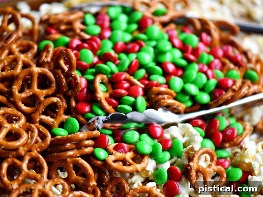 This wonderfully festive Christmas Snack Mix is the perfect easy treat all winter long! Both sweet and salty, this holiday snack mix is great for Christmas, movie nights, parties, gifts and so much more! A closer look at the delicious Snow Day Snack Mix in a bowl. // Mom On Timeout