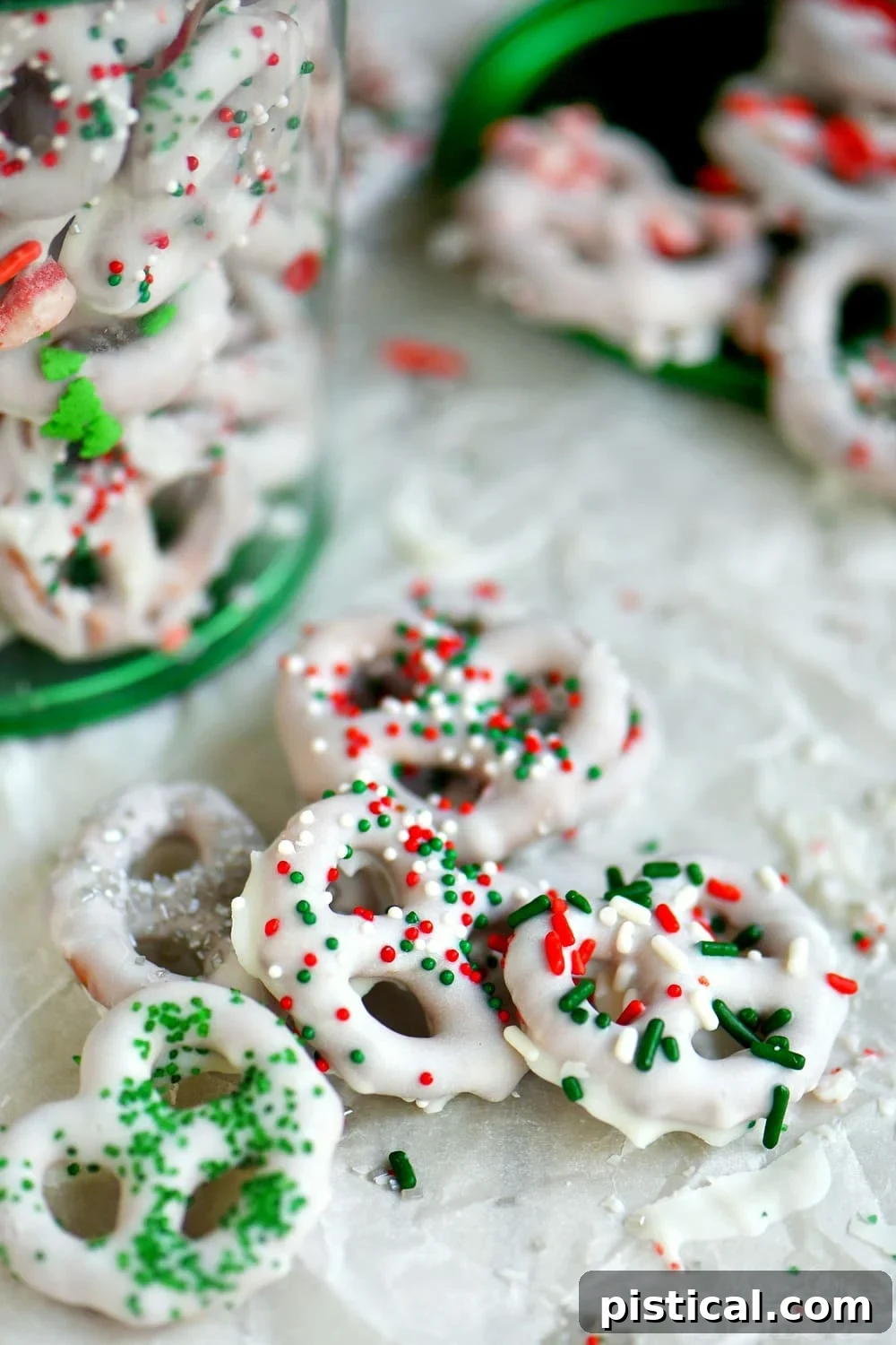 A close-up of white chocolate covered pretzels with sprinkles, perfect for Christmas and other holidays.