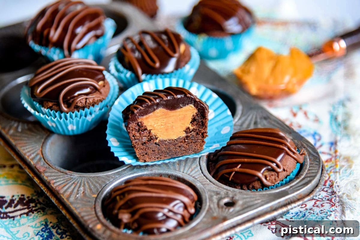 half of a buckeye bite sitting with other cookies on a vintage mini muffin pan.