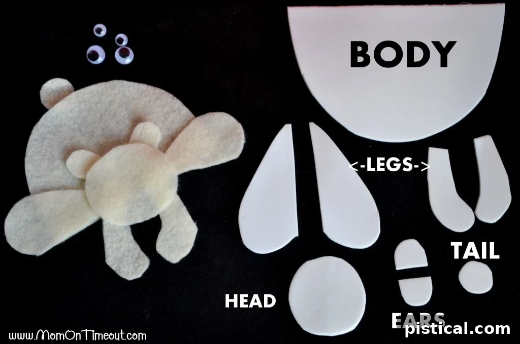 Polar bear ornament craft step-by-step assembly, showing cut out shapes and their pre-assembly layout on a surface.