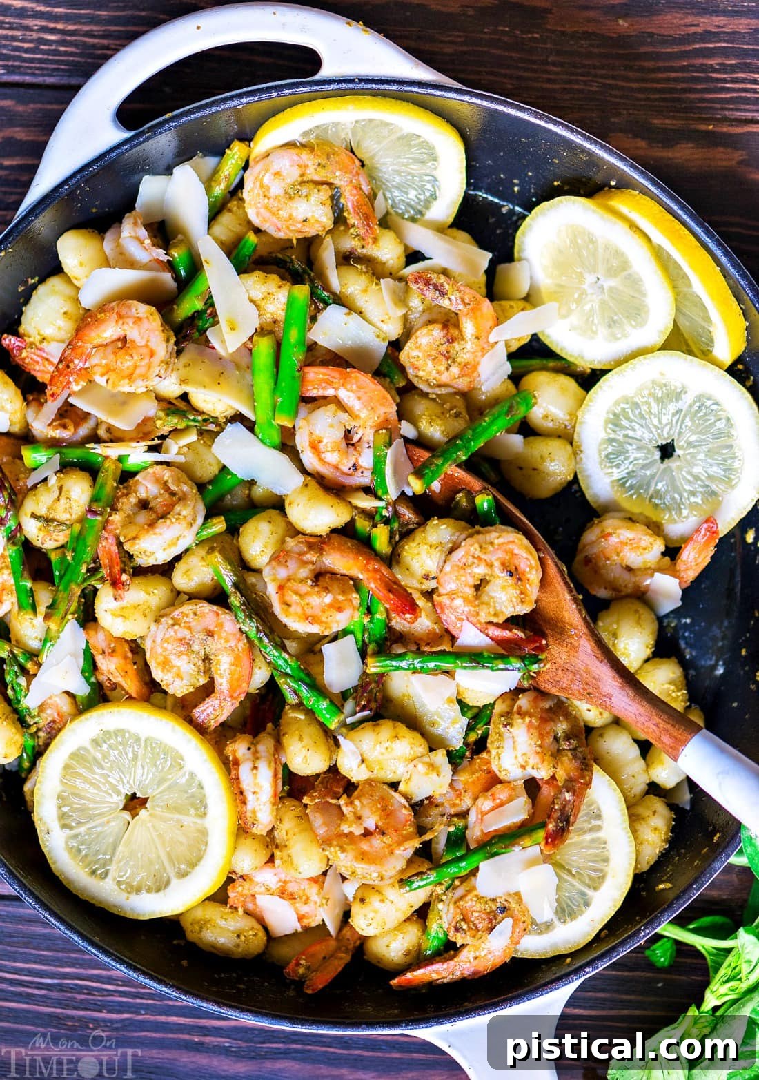 Skillet full of Pesto Shrimp with Gnocchi and Asparagus, ready to serve.