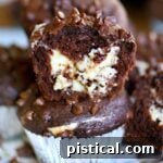 chocolate muffin split in half to show cheesecake filling