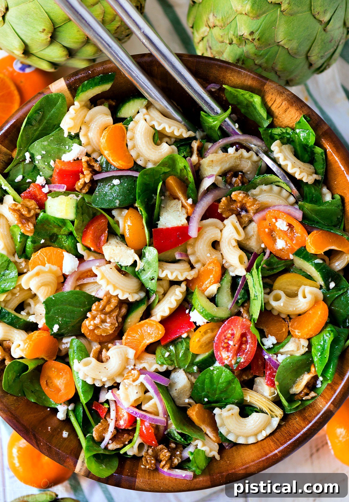 Perfect Pasta Salad: Your Go-To Dish for Summer Gatherings, Loaded with Artichokes, Spinach, and Sweet Mandarins. A vibrant Perfect Pasta Salad with artichokes, spinach, mandarins, bell peppers, tomatoes, and feta, served in a large bowl. Ideal for summer BBQs and potlucks.