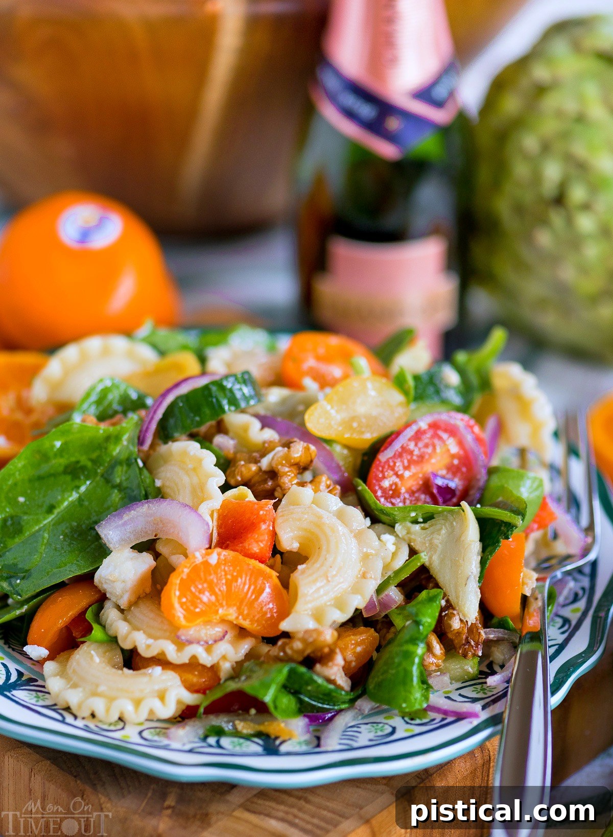 Perfect Pasta Salad Recipe: A Refreshing Mix of Artichokes, Spinach, Mandarins, and a Zesty Dressing. A generous serving of Perfect Pasta Salad in a bowl, with the vibrant dressing drizzled over, highlighting the fresh ingredients.