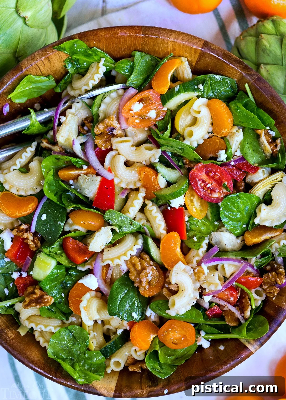 Perfect Pasta Salad: A Refreshing and Easy Recipe Featuring Artichokes, Spinach, Mandarins, and a Sparkling Wine Dressing. A final presentation of the Perfect Pasta Salad in a large serving bowl, garnished with fresh herbs and ready to be enjoyed.