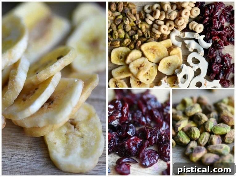 Ingredients for an easy and delicious Breakfast Trail Mix, combining sweet, salty, and crunchy elements. A selection of ingredients for Breakfast Trail Mix including dried cranberries, pistachios, banana chips, Honey Nut Cheerios, and yogurt covered pretzels.