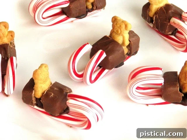 Teddy Sleighs Creative Milky Way teddy sleds, featuring small teddy bear crackers perched on candy cane sleighs made with Milky Way candy bars, a sweet and fun holiday project.