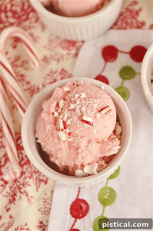 peppermint ice cream Scoops of refreshing peppermint ice cream, garnished with fresh mint leaves and crushed candy cane pieces, presented in an elegant bowl, perfect for a winter treat.