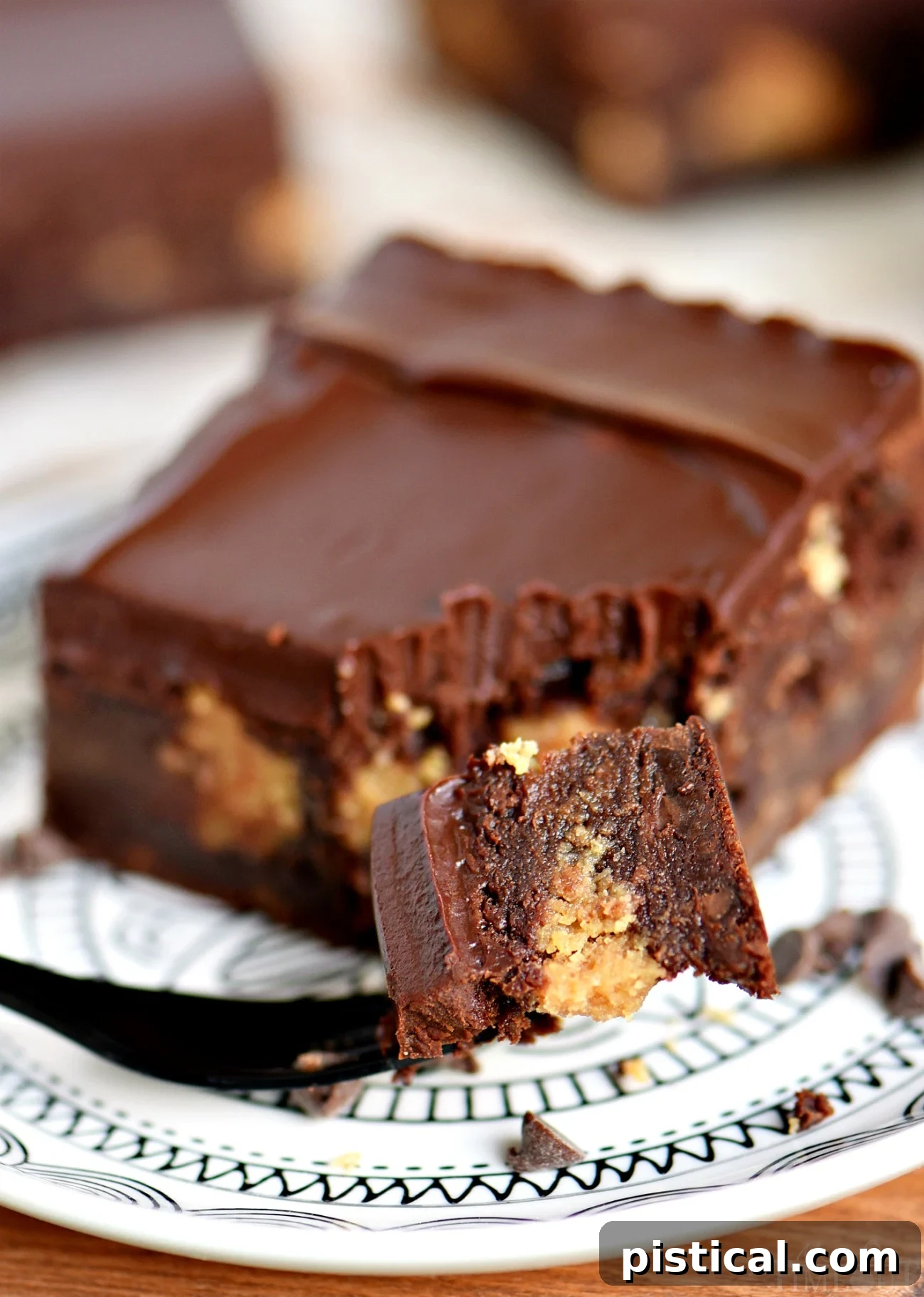 Decadent fudgy brownies with a hidden peanut butter layer and chocolate ganache