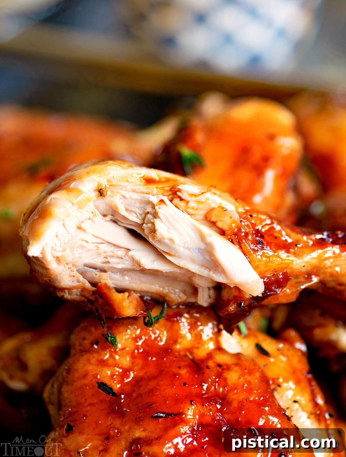Close-up of a succulent piece of honey balsamic glazed chicken on a fork, showcasing its tender texture and rich glaze.