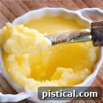 A jar of homemade clarified butter with a small spoon.