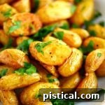 Garlic Roasted Potatoes plated and garnished with parsley